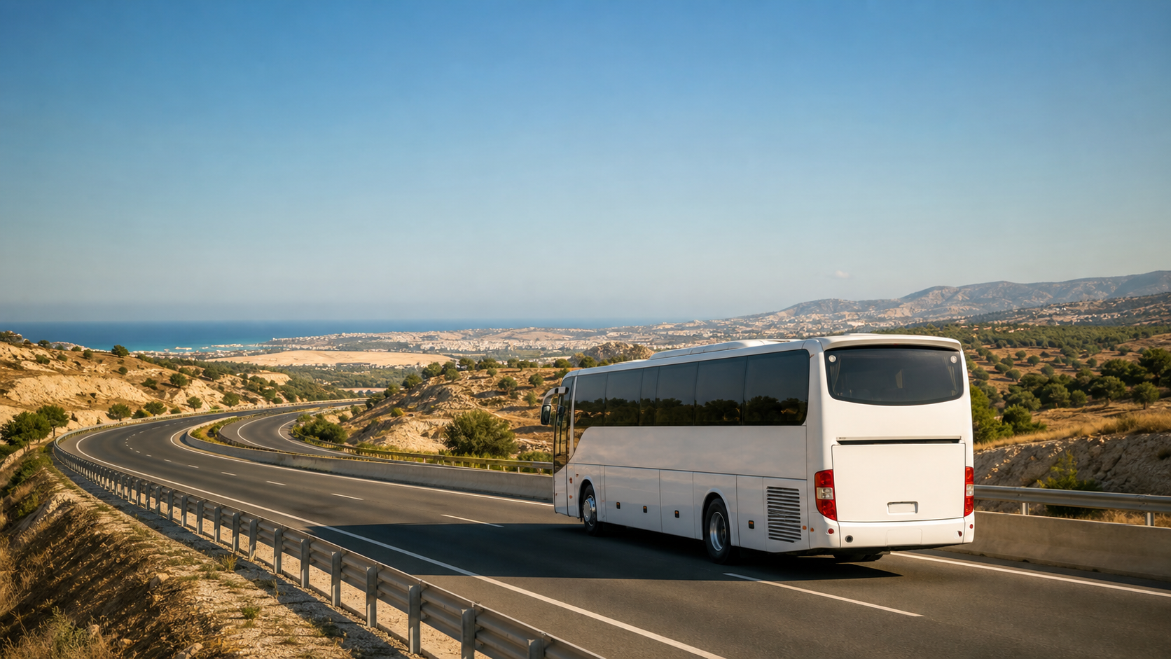 An unbranded white airport coach travelling on a sunlit Cyprus motorway towards Nicosia